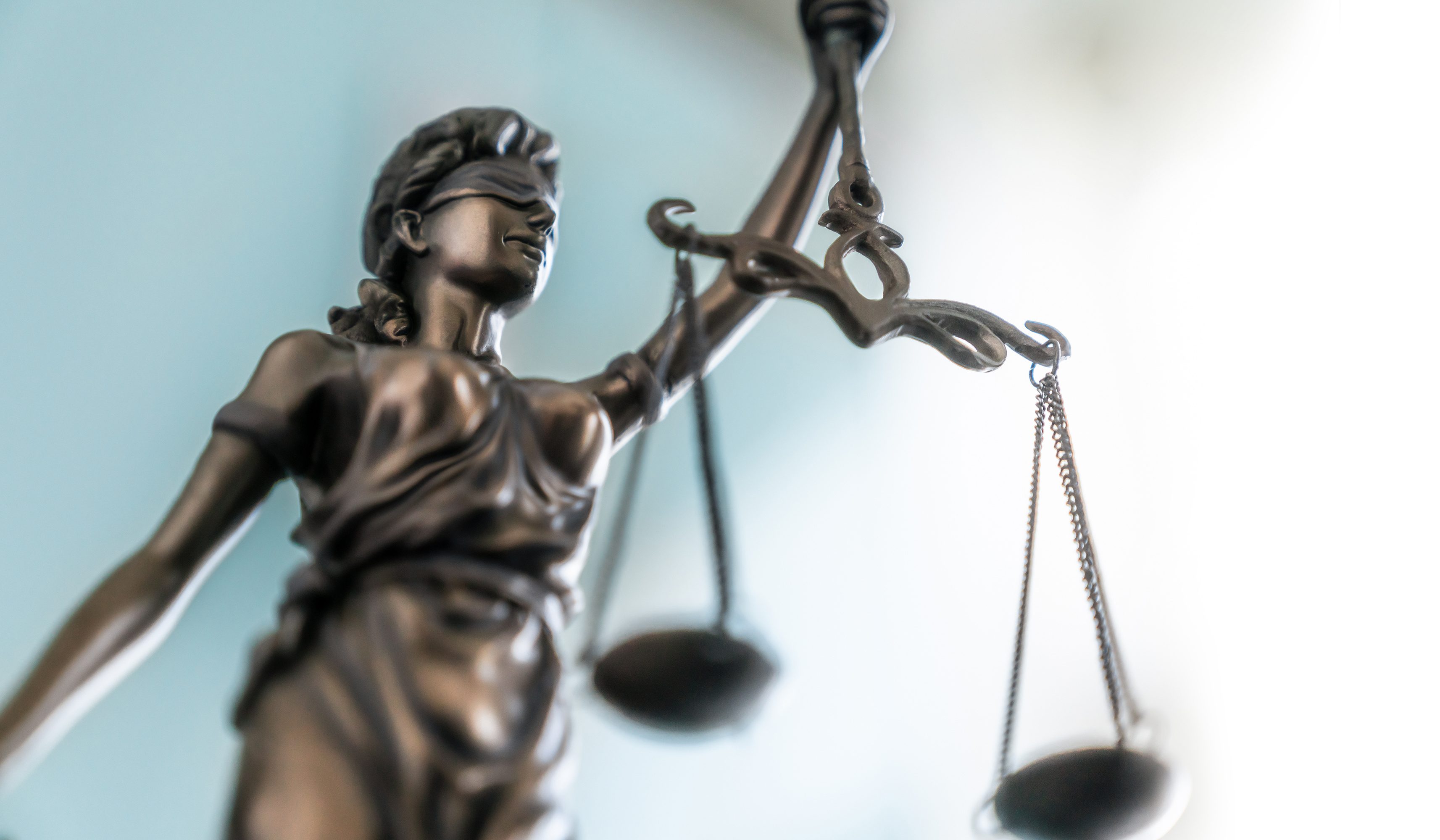 A statue of Justice wearing blindfold and brandishing a scale, symbolizing the law and justice.